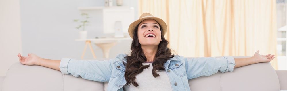 Woman happy at home after Air Conditioning installation in Ferndale, MI