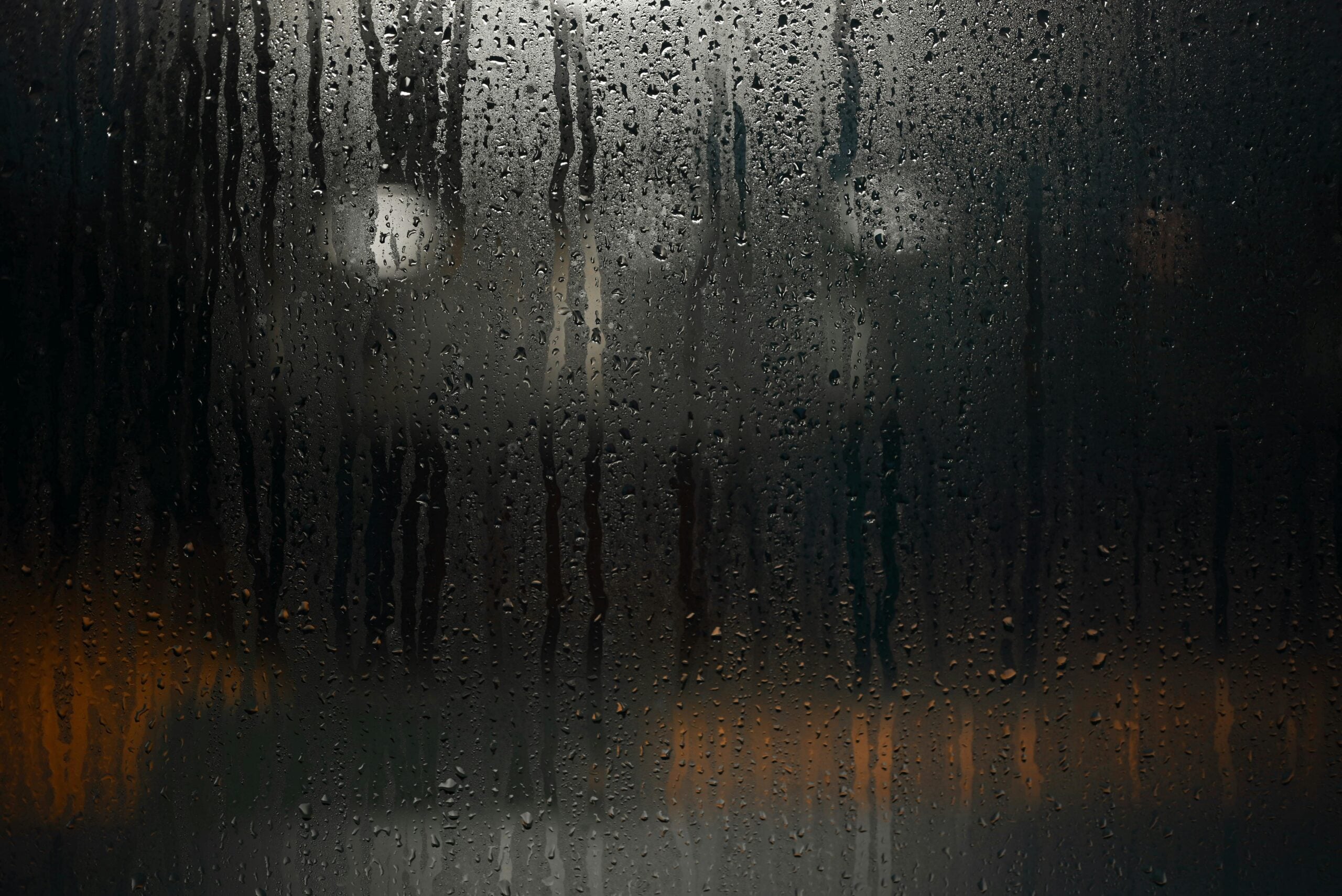 Condensation and moisture buildup on a window, illustrating excess indoor humidity and the need for whole-home dehumidification in Michigan homes.